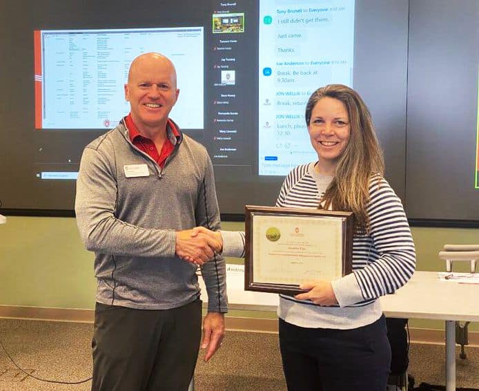 Student receiving certification from Program Director Jon Wellik