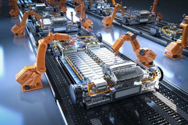 Robot arms assembling parts in an automated manufacturing facility